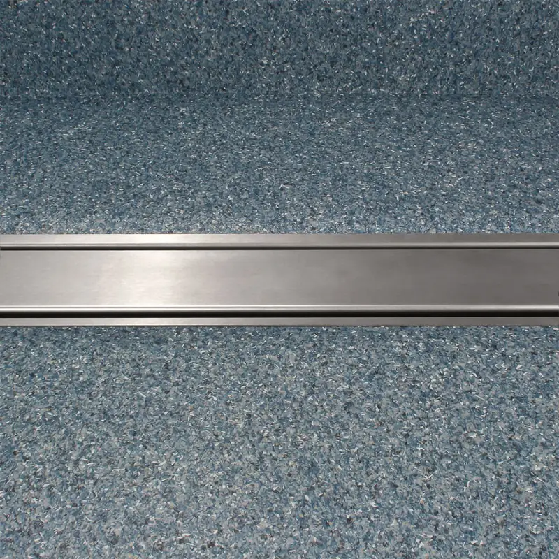 Wiper VF clamp drain with its grating fitted, set into a speckled vinyl floor
